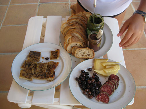 Our first market meal: pissaladiere, saucisson, olives, cheese, tapenade, and pistou